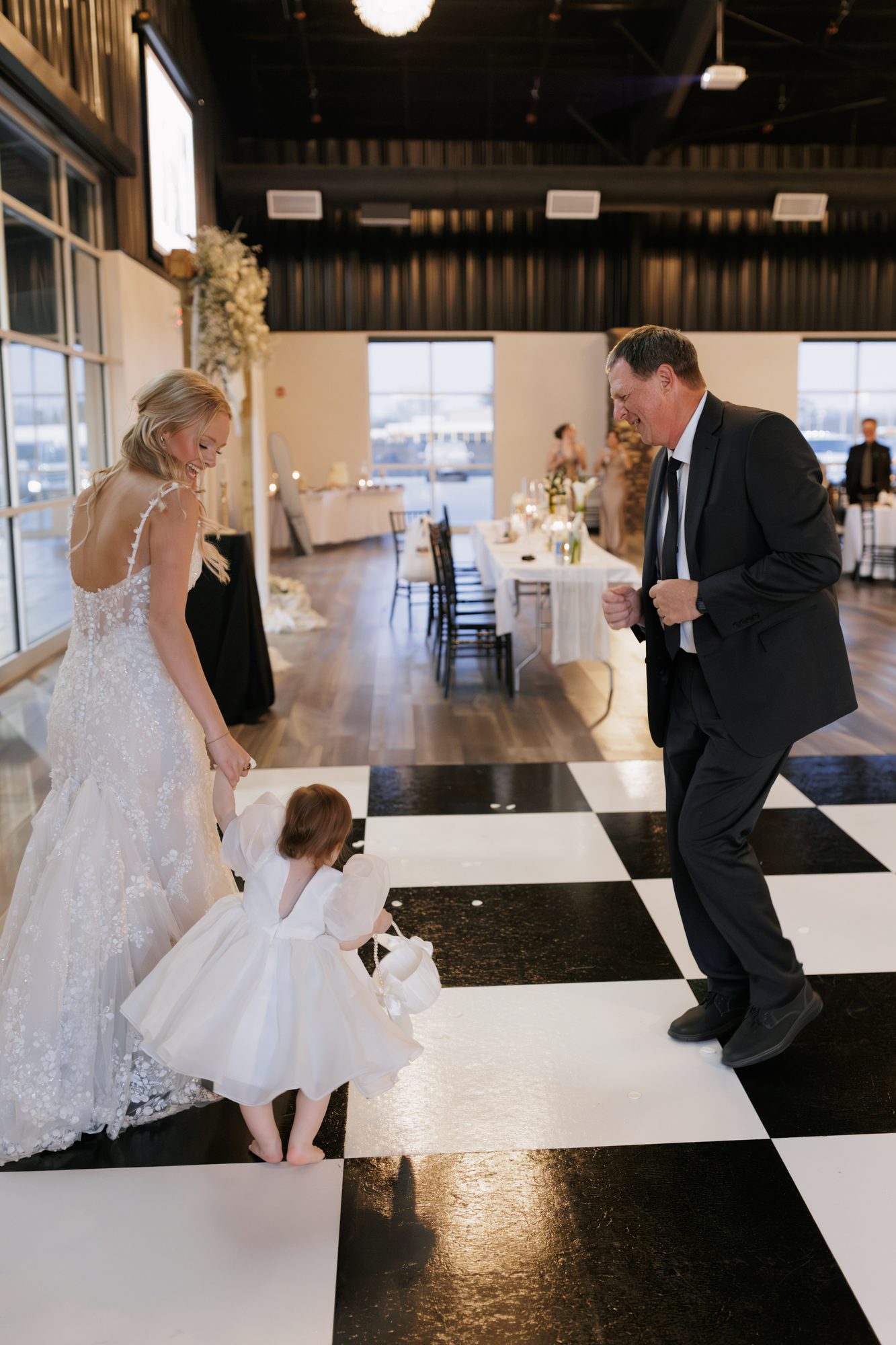 Bride dancing with family on the checkered floor