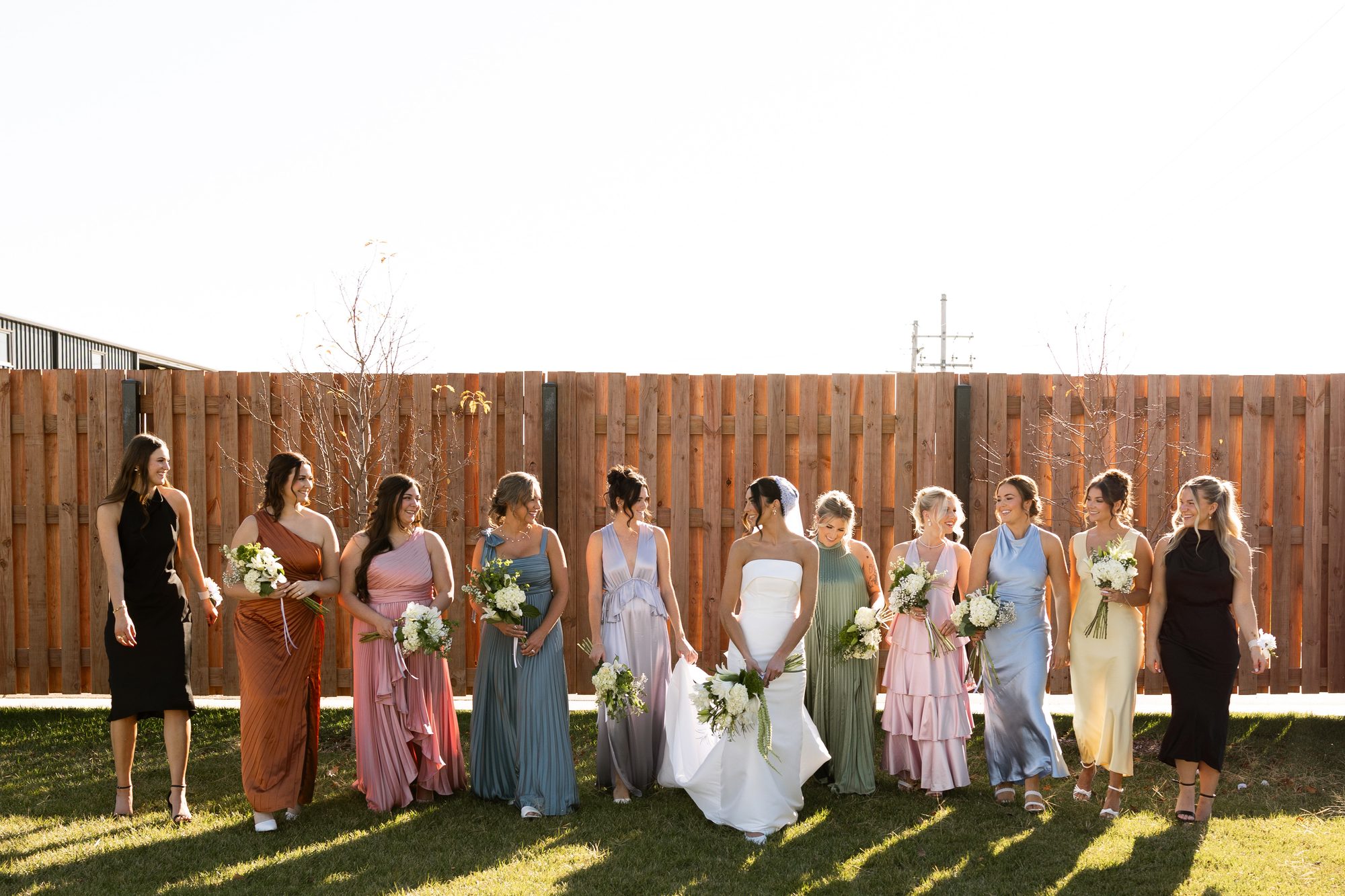 Bridesmaids walking the courtyard lawn