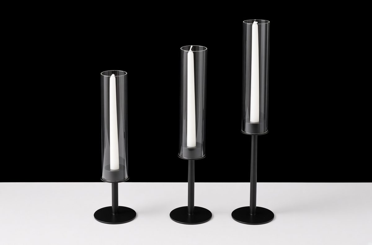 Black candle holders paired with glass hurricane vases